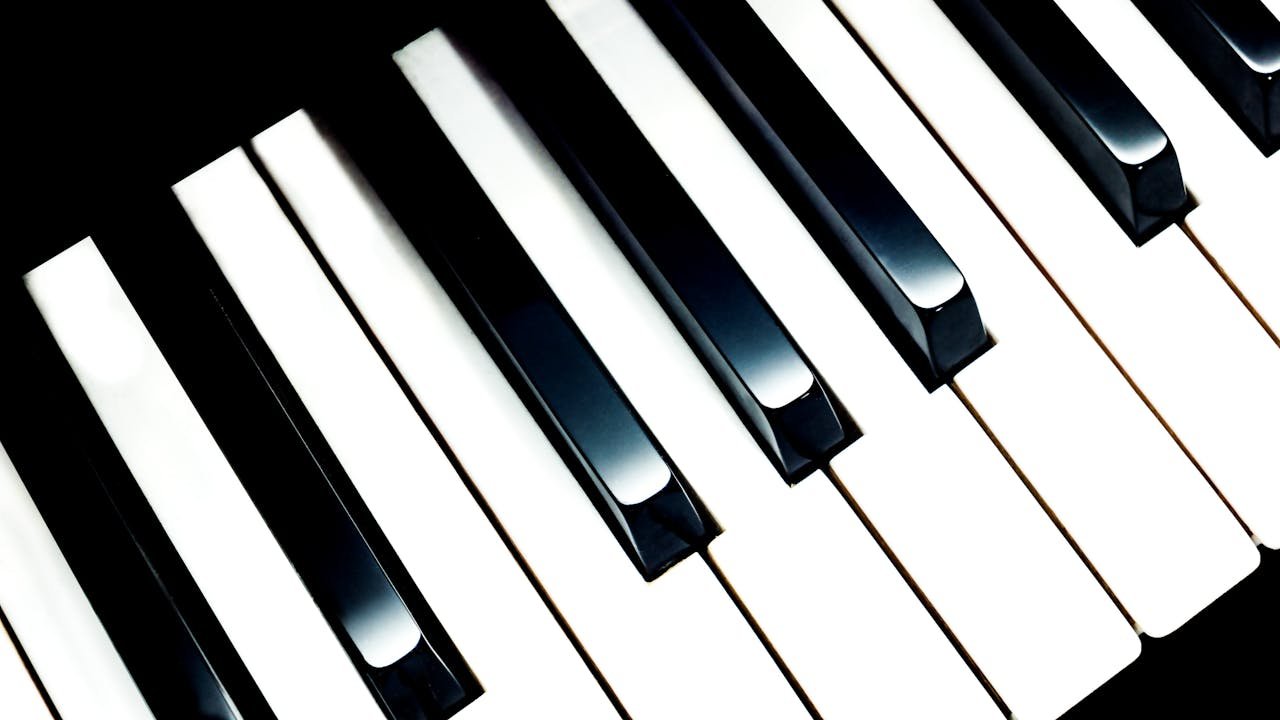 Detailed close-up image of piano keys, showcasing classic black and white contrast.