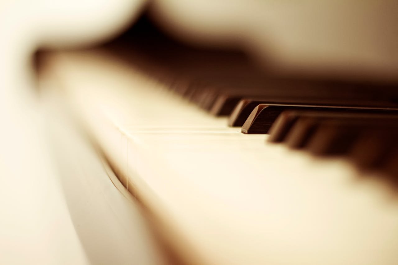 Artistic close-up of piano keys with a blurred effect, capturing elegance and depth.